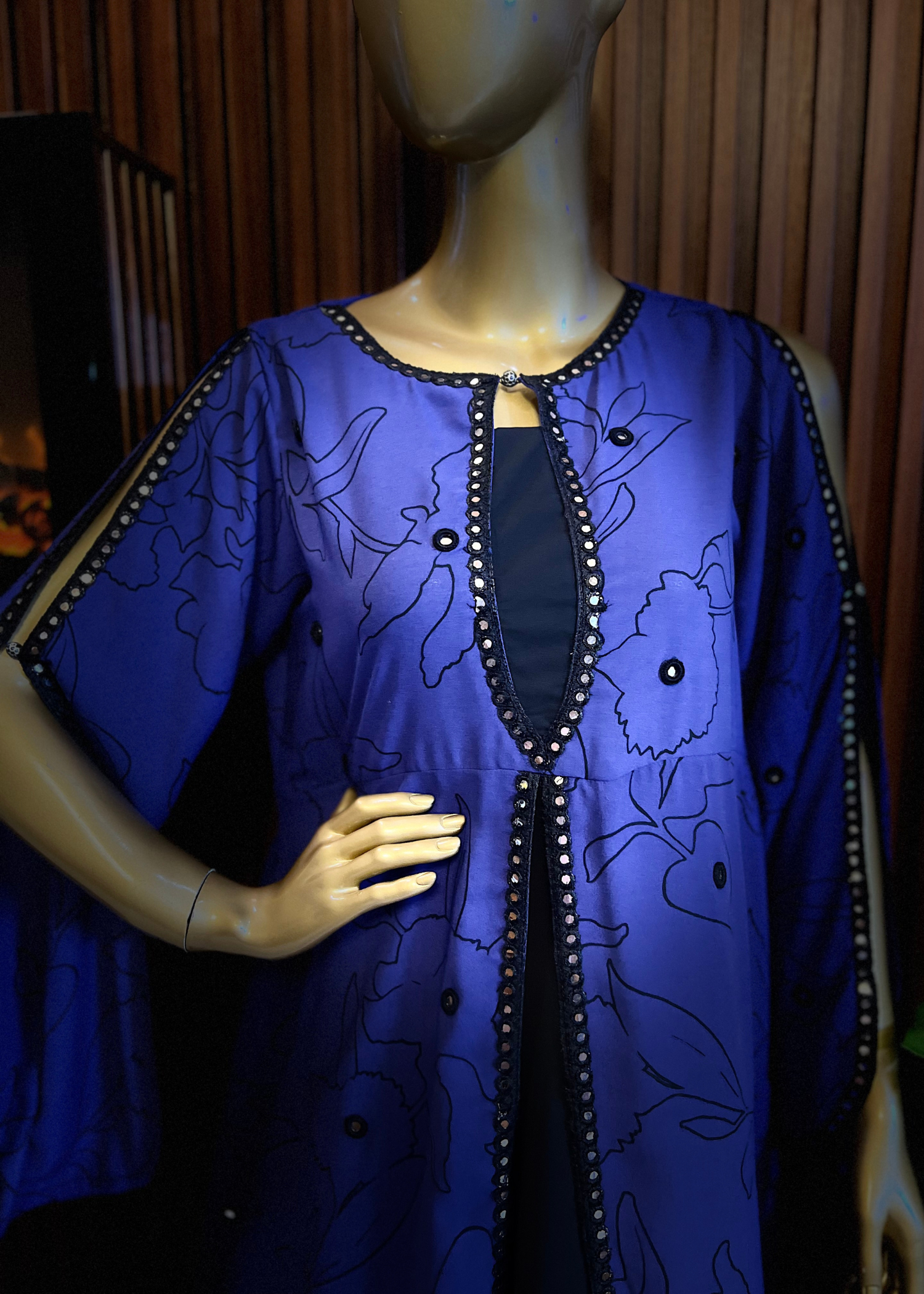 “Royal blue embroidered cape dress by Rooh-e-Maan Studios featuring elegant floral detailing, pearl embellishments, and a flowy silhouette — perfect for festive and formal occasions.”
