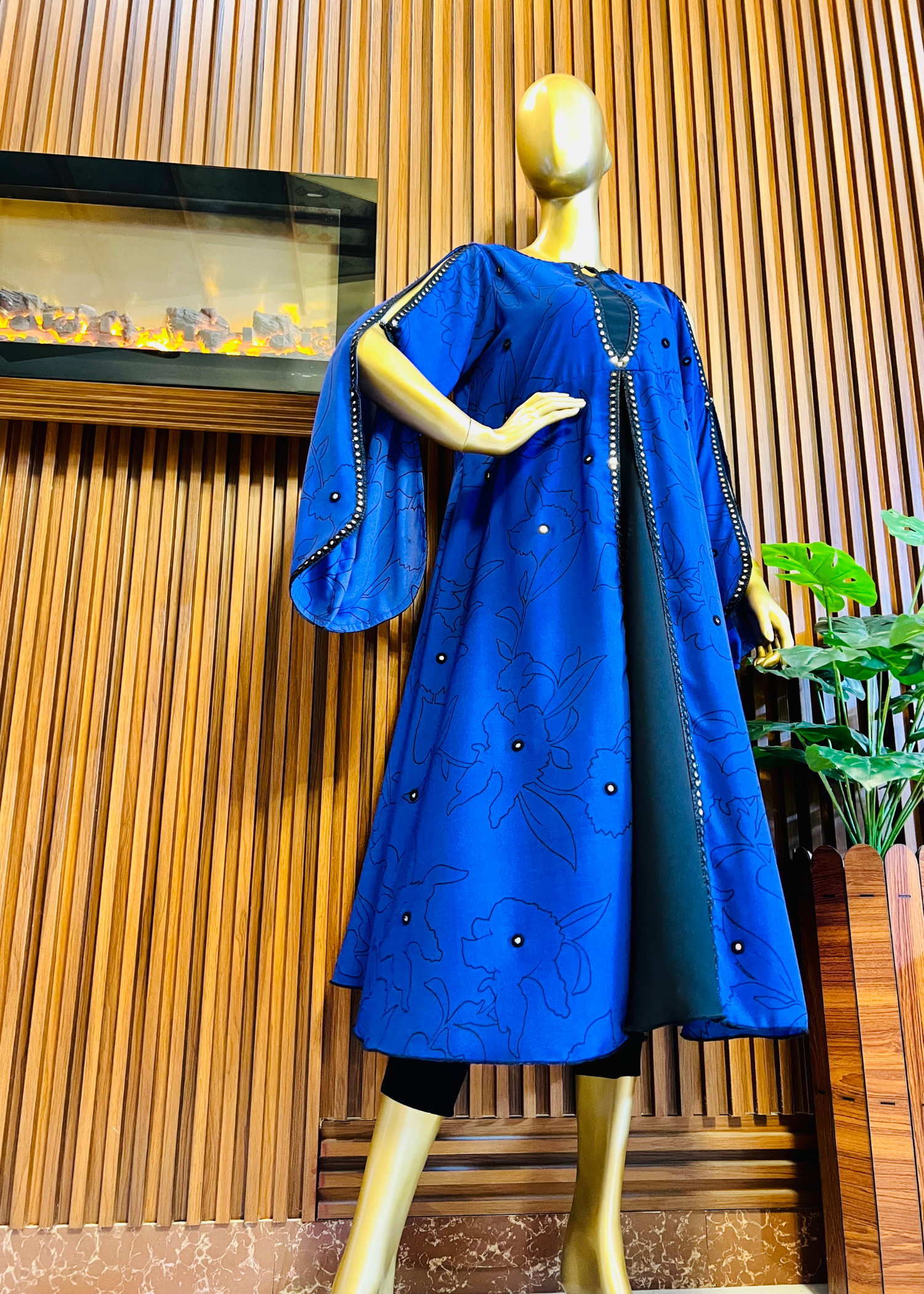 “Royal blue embroidered cape dress by Rooh-e-Maan Studios featuring elegant floral detailing, pearl embellishments, and a flowy silhouette — perfect for festive and formal occasions.”