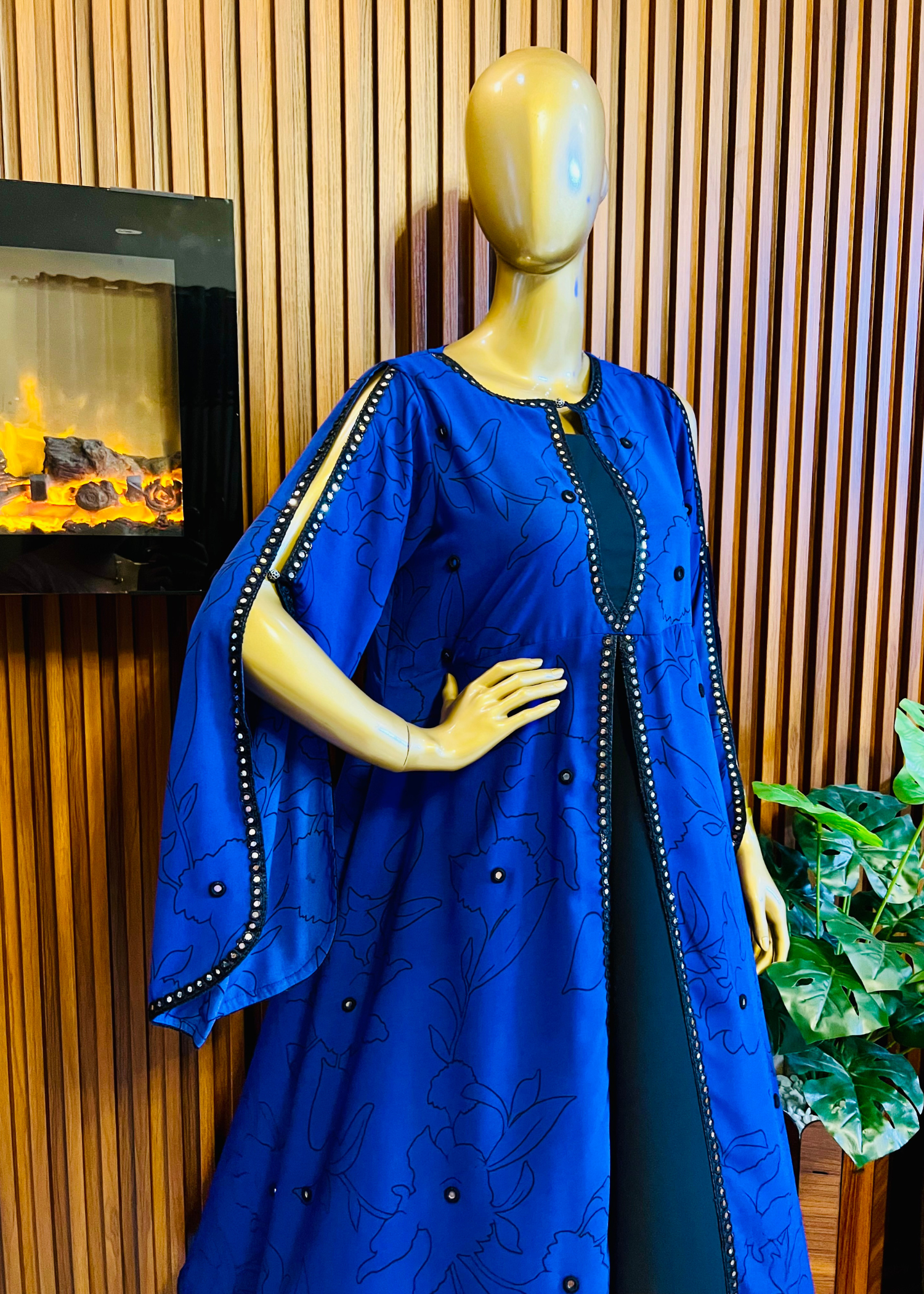 “Royal blue embroidered cape dress by Rooh-e-Maan Studios featuring elegant floral detailing, pearl embellishments, and a flowy silhouette — perfect for festive and formal occasions.”