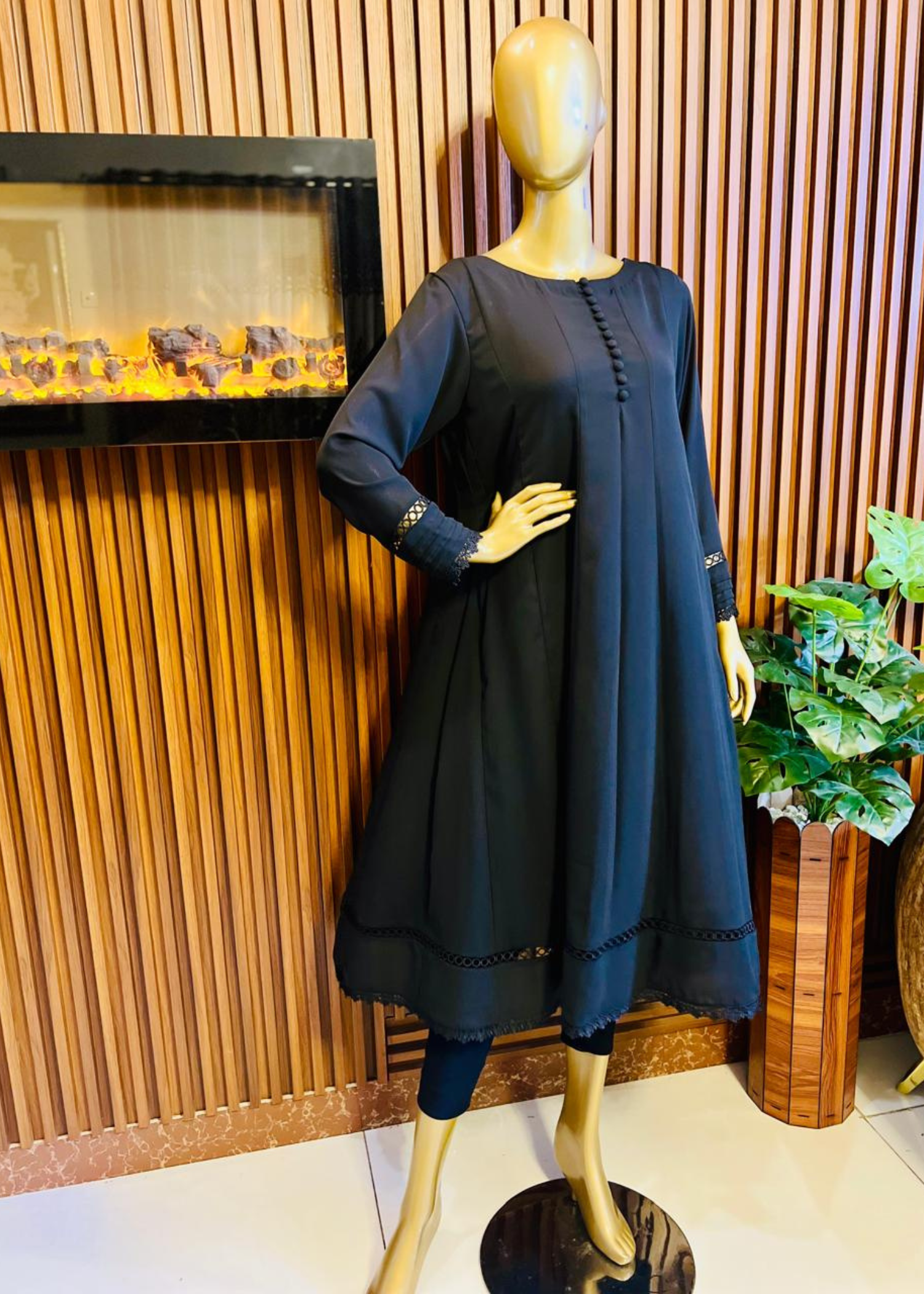 "Elegant black A-line frock with flared silhouette and delicate detailing – perfect for festive and winter occasions by Rooh-e-Maan Studios"