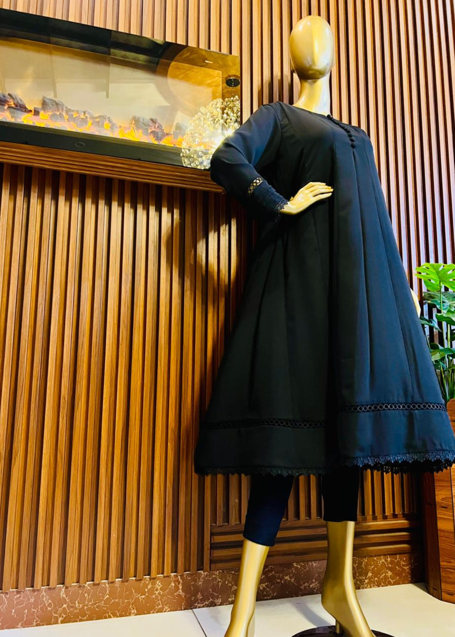 "Elegant black A-line frock with flared silhouette and delicate detailing – perfect for festive and winter occasions by Rooh-e-Maan Studios"