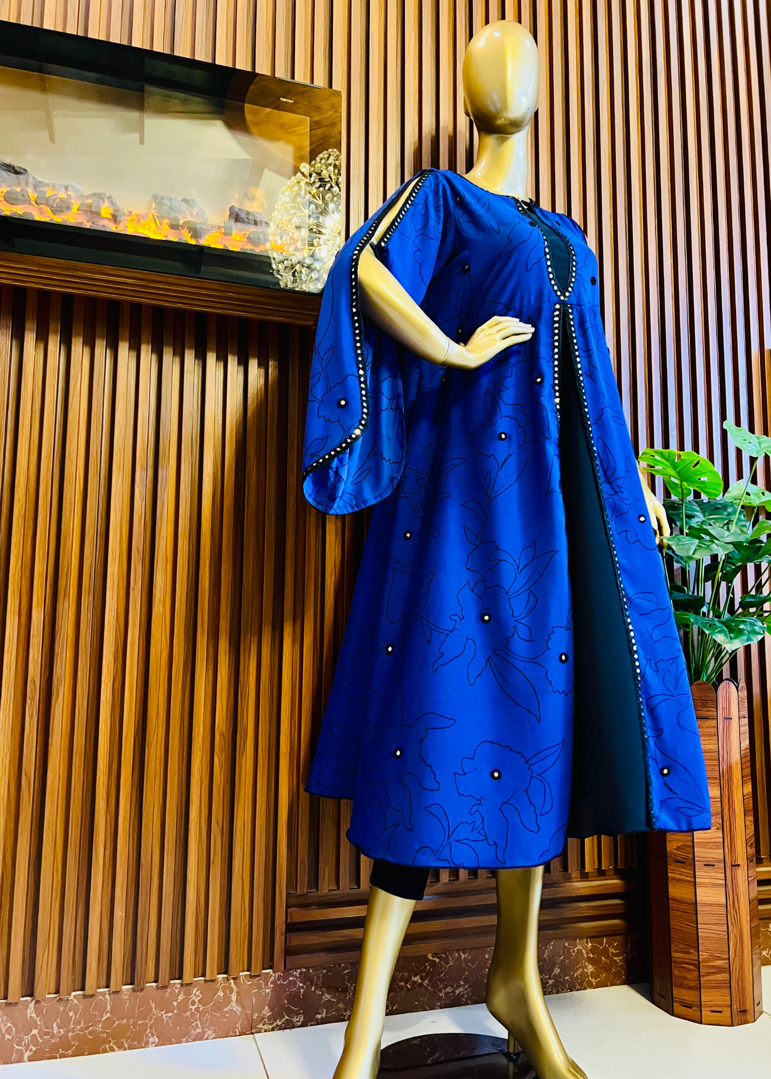 “Royal blue embroidered cape dress by Rooh-e-Maan Studios featuring elegant floral detailing, pearl embellishments, and a flowy silhouette — perfect for festive and formal occasions.”